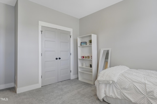 bedroom featuring light colored carpet and a closet