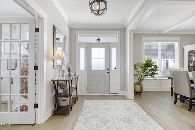 foyer entrance featuring light wood-type flooring and ornamental molding