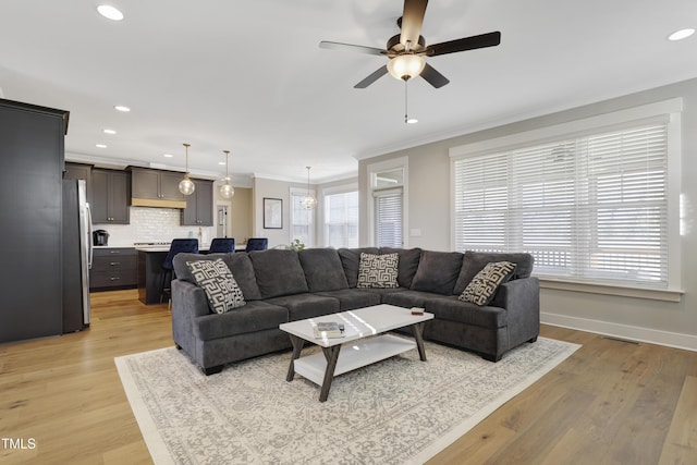 living room with ceiling fan, light hardwood / wood-style floors, and ornamental molding