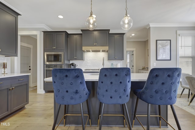 kitchen featuring gray cabinets, stainless steel oven, hanging light fixtures, and built in microwave