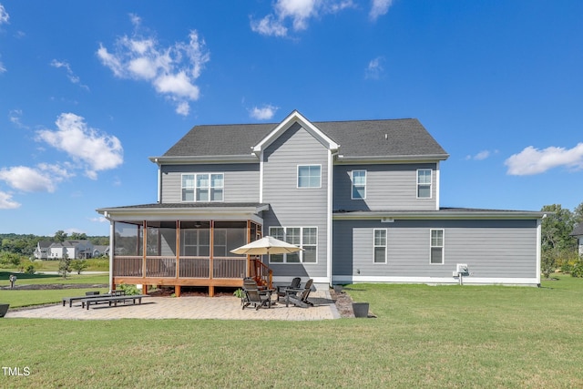 back of house with a lawn, a patio area, and a sunroom