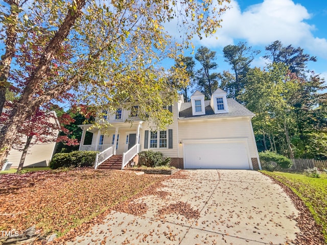 view of front of property featuring a garage and a porch