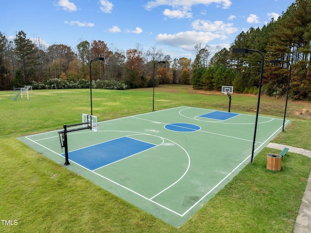 view of basketball court with a yard