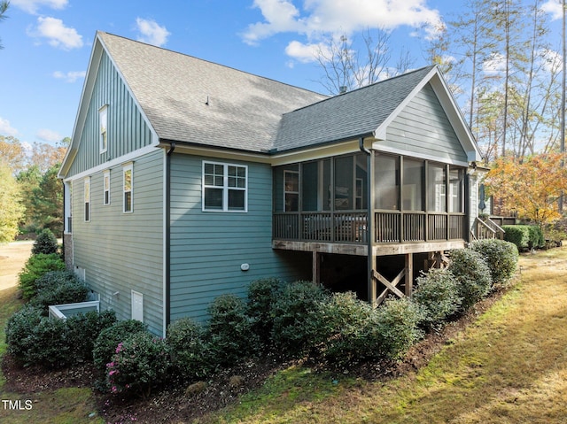 back of property with a sunroom