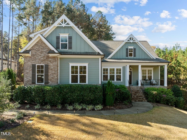 181 Colonial Ridge Dr, Pittsboro, NC 27312 - view of front of property featuring stairway, board and batten siding, covered porch, and a front lawn