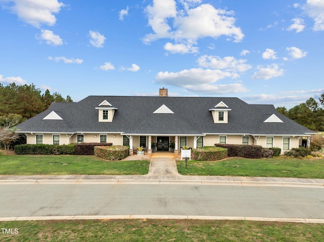 cape cod house with covered porch and a front yard