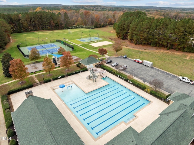 view of swimming pool featuring tennis court