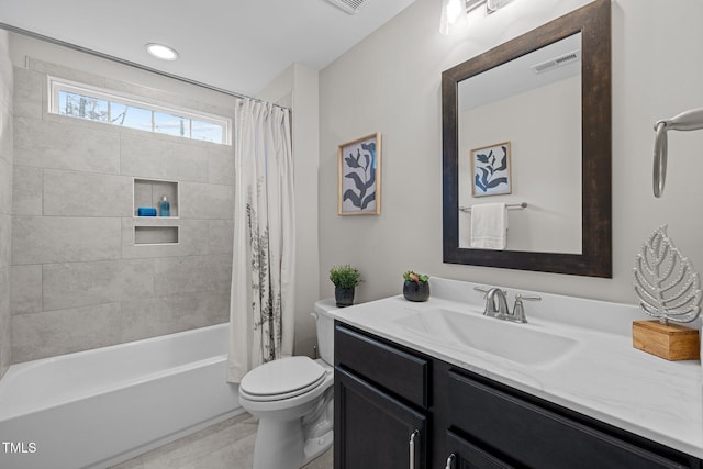 full bathroom featuring vanity, shower / bath combination with curtain, and toilet