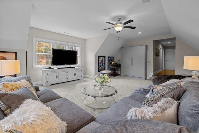 carpeted living room featuring ceiling fan and lofted ceiling