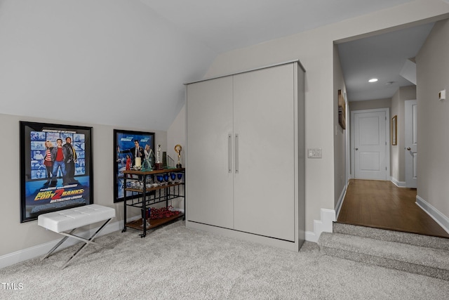 interior space with light carpet and lofted ceiling