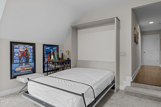 carpeted bedroom with lofted ceiling