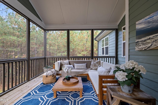 sunroom / solarium featuring vaulted ceiling