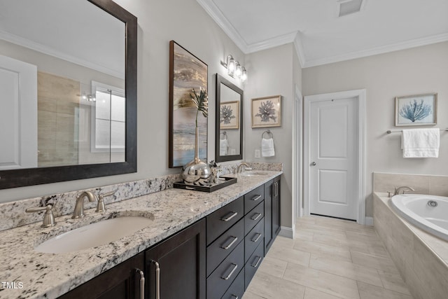 bathroom with vanity, crown molding, and tiled tub