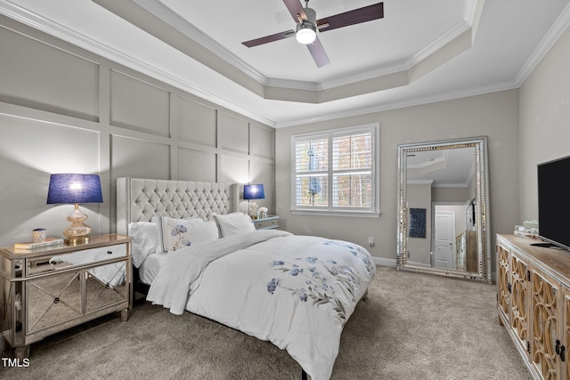 bedroom featuring carpet floors, a raised ceiling, ceiling fan, and ornamental molding