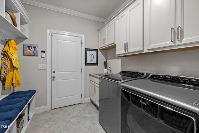 washroom featuring sink, cabinets, independent washer and dryer, and crown molding