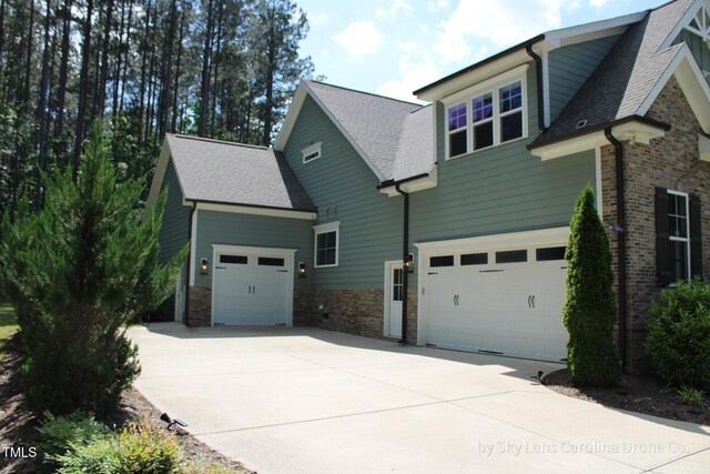 181 Colonial Ridge Dr, Pittsboro, NC 27312 - view of front of house with driveway, brick siding, and a shingled roof