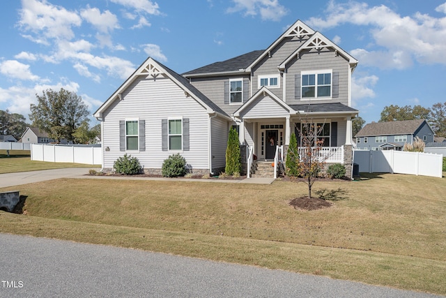 craftsman house with a front yard and a porch