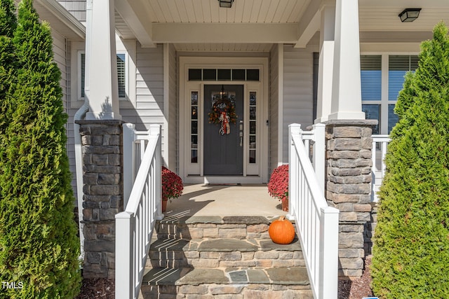 view of exterior entry with covered porch