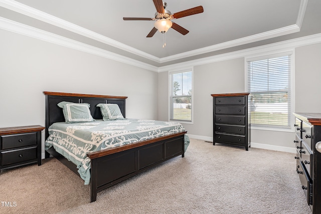 carpeted bedroom featuring crown molding, ceiling fan, and a raised ceiling