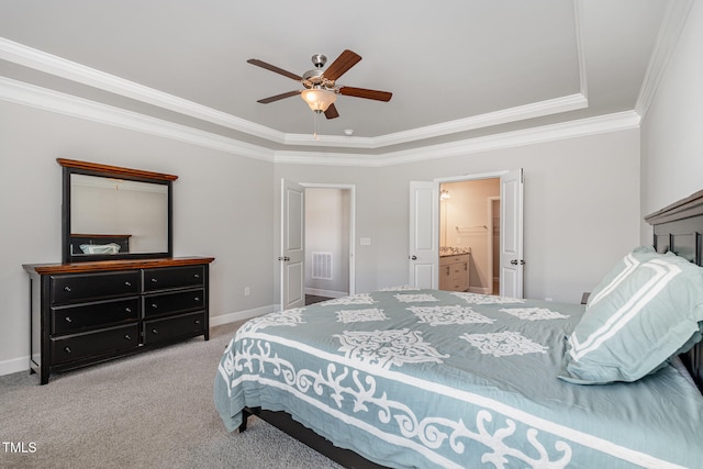 bedroom featuring connected bathroom, light carpet, ceiling fan, and crown molding