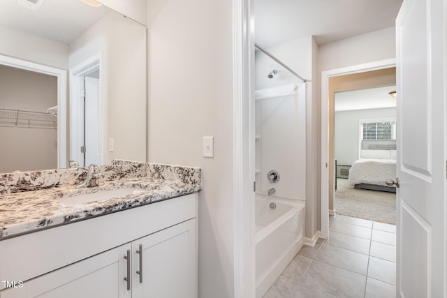 bathroom featuring vanity, tile patterned flooring, and shower / bathtub combination