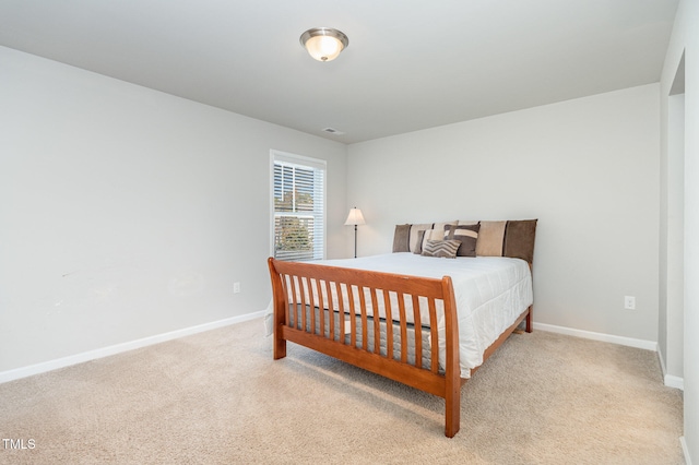 bedroom featuring light carpet