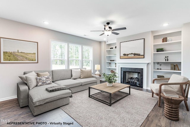 living room featuring ceiling fan and hardwood / wood-style floors