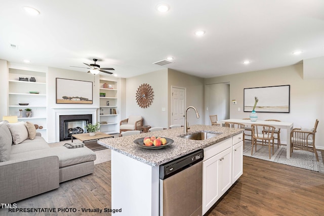 kitchen featuring sink, light stone counters, white cabinets, a center island with sink, and stainless steel dishwasher