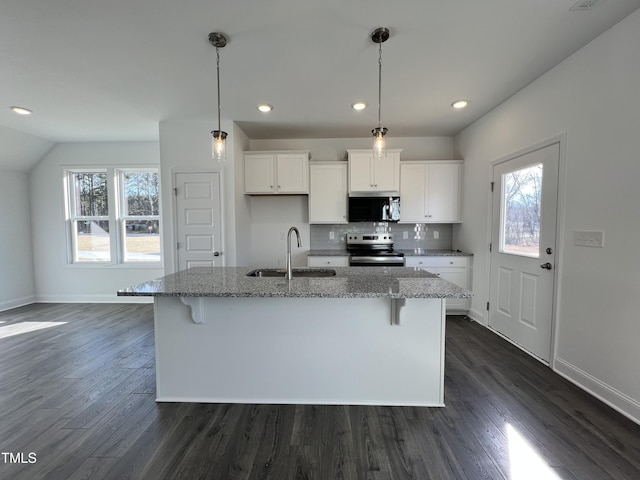 kitchen featuring stainless steel appliances, light stone countertops, sink, and white cabinets