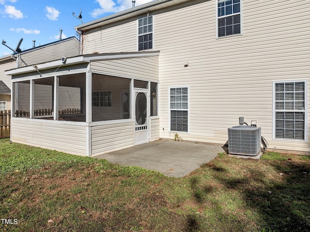 back of property featuring a lawn, central AC, a sunroom, and a patio