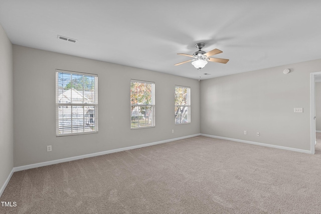 carpeted empty room featuring ceiling fan