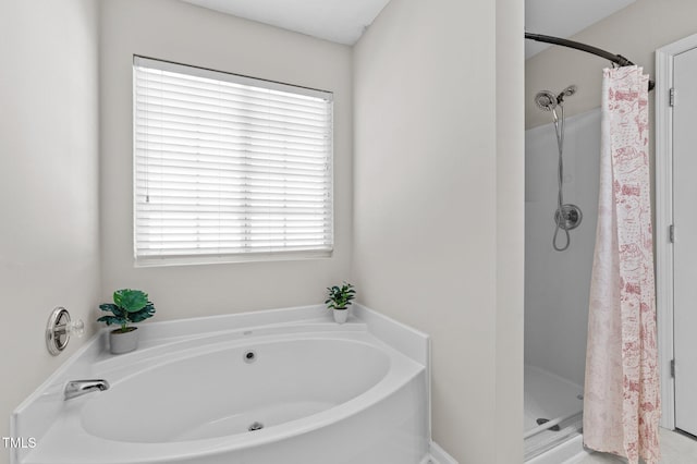 bathroom featuring independent shower and bath