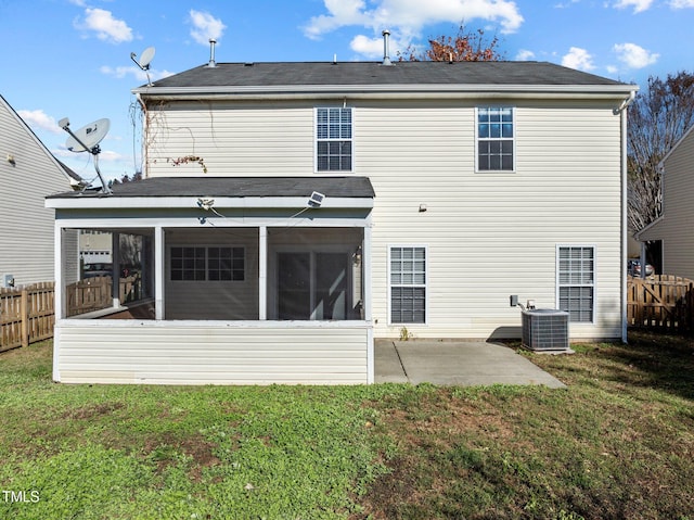 back of house featuring central AC, a lawn, a patio area, and a sunroom