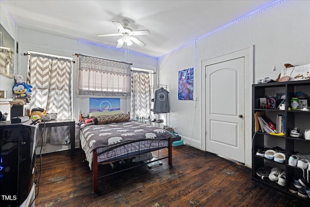 bedroom featuring ceiling fan and dark hardwood / wood-style floors