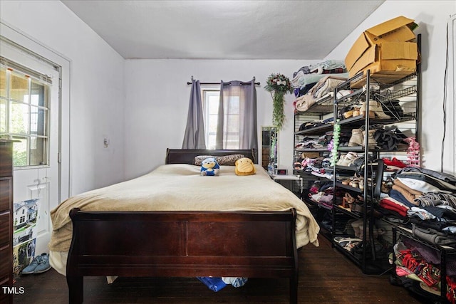 bedroom with dark hardwood / wood-style floors