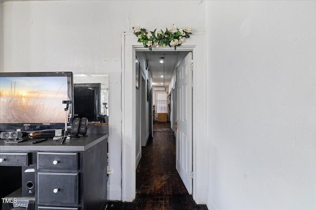 corridor with dark hardwood / wood-style flooring