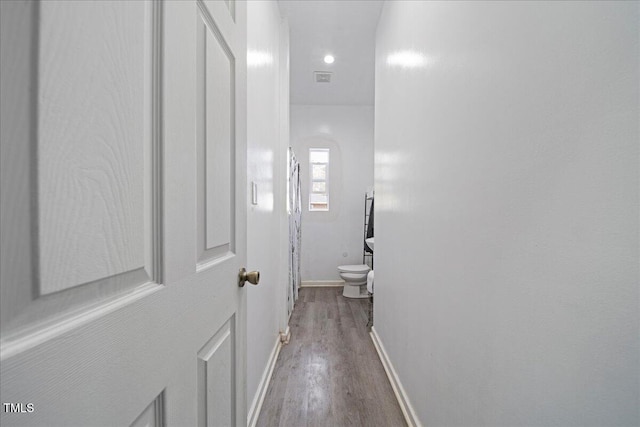 hallway with hardwood / wood-style flooring