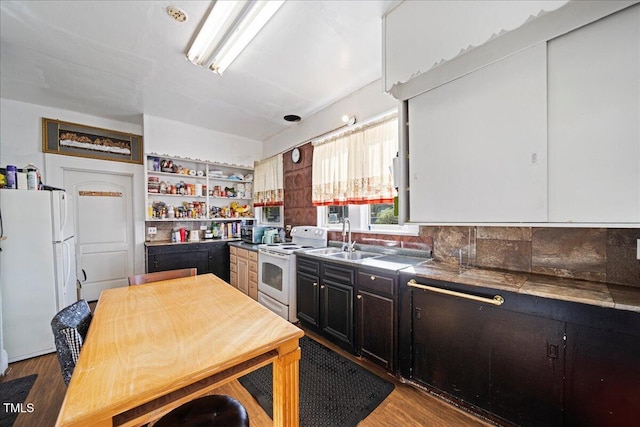 kitchen featuring light hardwood / wood-style flooring, tasteful backsplash, sink, and white appliances