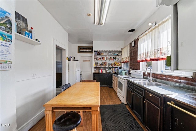 kitchen featuring sink, white appliances, and dark hardwood / wood-style floors