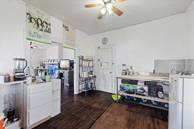 kitchen featuring white refrigerator, dark hardwood / wood-style floors, ceiling fan, backsplash, and white cabinetry