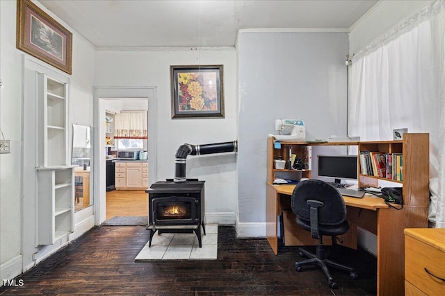 office space featuring a wood stove, crown molding, and wood-type flooring