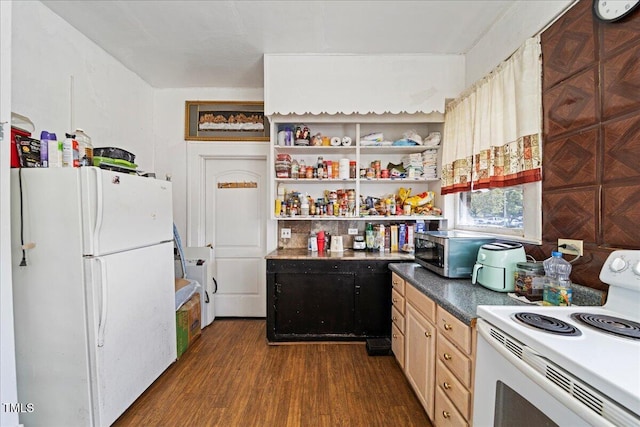 kitchen featuring white appliances, washer / dryer, and dark hardwood / wood-style flooring