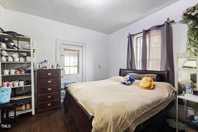 bedroom with dark hardwood / wood-style flooring