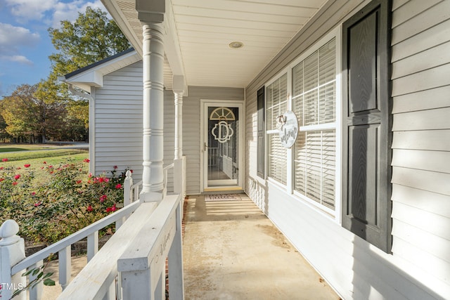 view of exterior entry with a porch