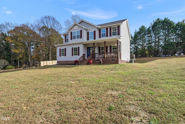 view of front of home with central air condition unit, a porch, and a front lawn