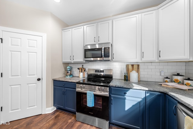 kitchen with light stone counters, appliances with stainless steel finishes, dark hardwood / wood-style flooring, white cabinets, and blue cabinets