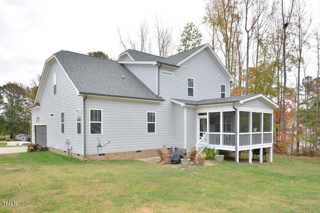 back of property featuring a lawn, a sunroom, and a garage