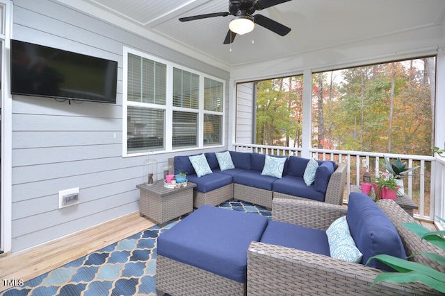 sunroom featuring ceiling fan