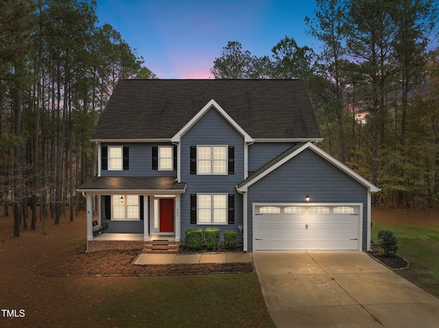 view of front of house with a garage and covered porch