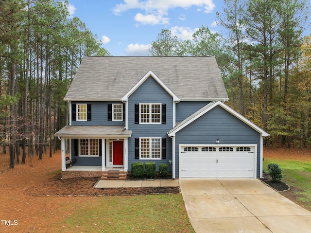 5600 Thornburg Dr, Wake Forest, NC 27587 - view of front of house featuring a garage, driveway, a front yard, and covered porch